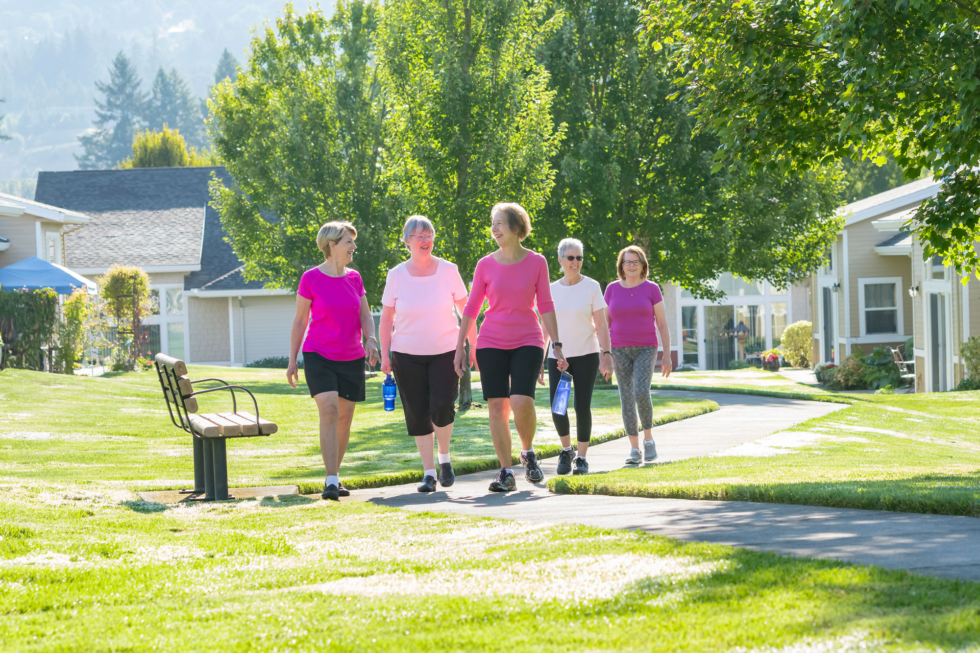 A group of senior women are walking on the campus of the Friendsview senior living community