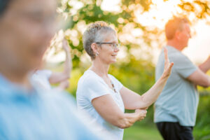 Senior woman in outdoor exercise class