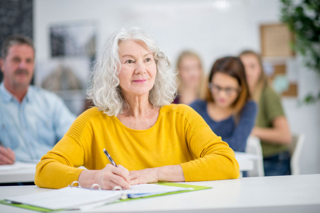 Senior woman participating in lifelong learning at a class