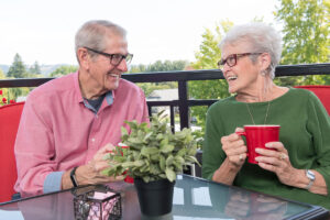 Senior couple outside having coffee