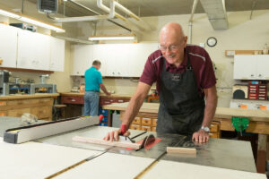 Senior man doing woodshop project