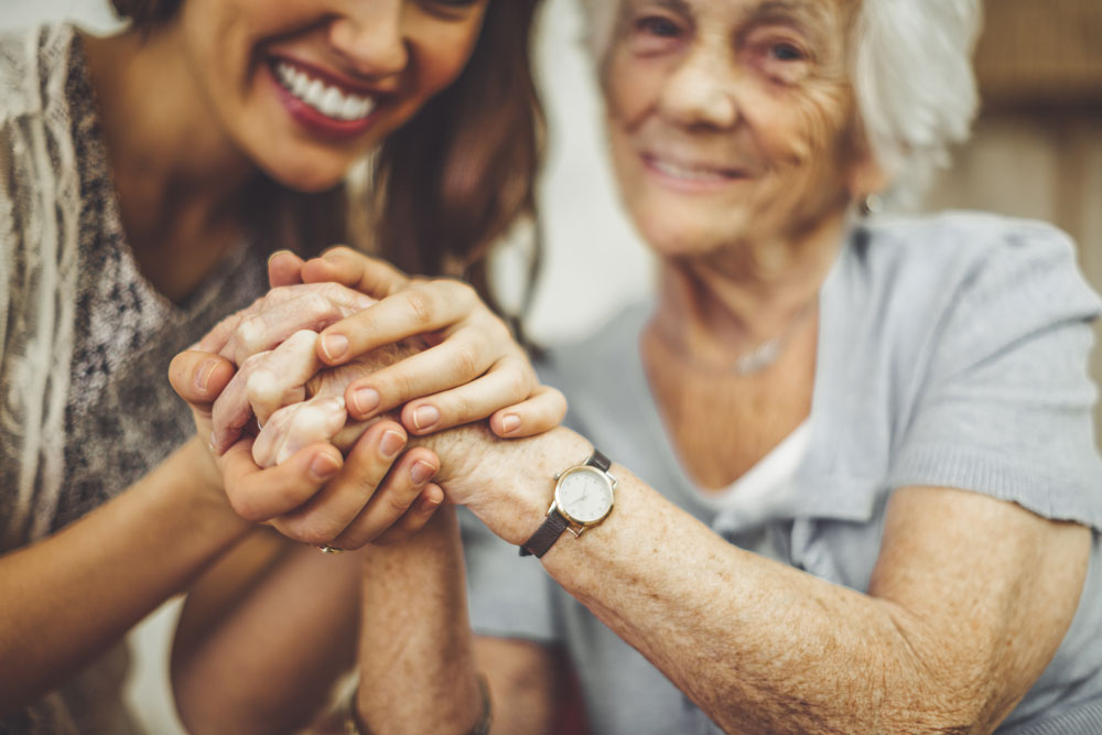 Senior and loved one holding hands