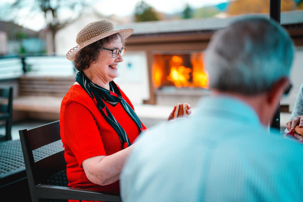 A senior woman has lunch with friends