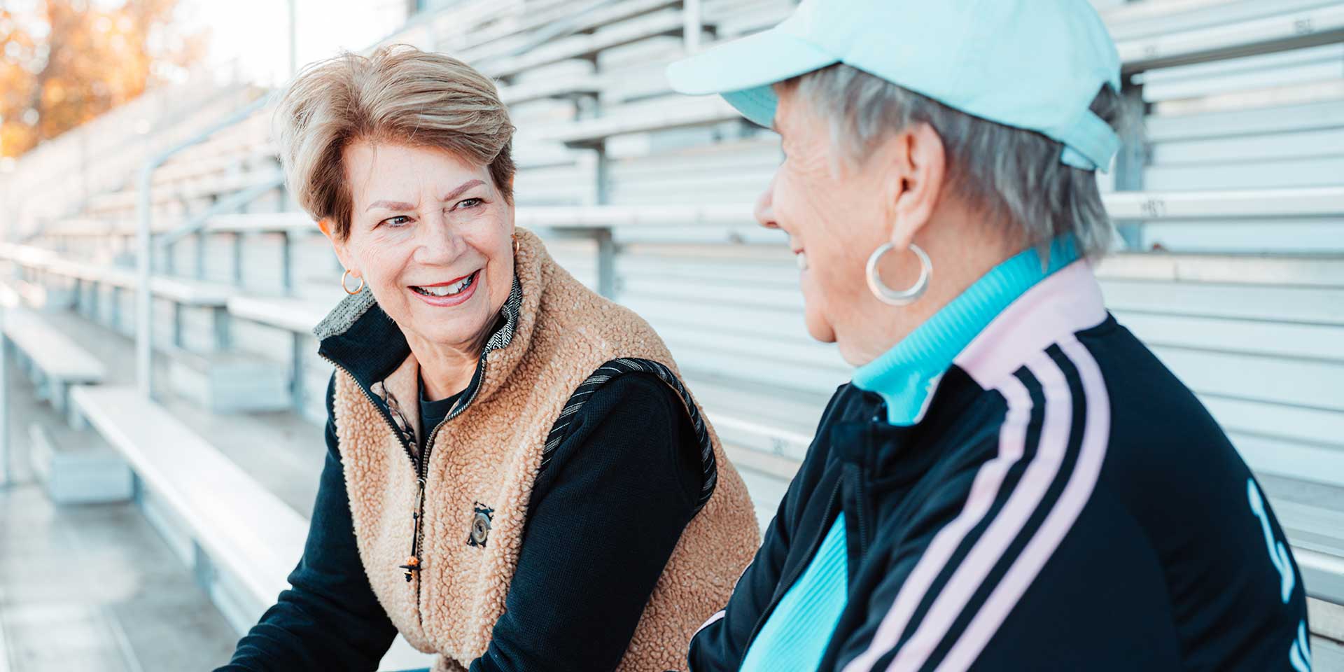 Retired friends sitting on the bleachers
