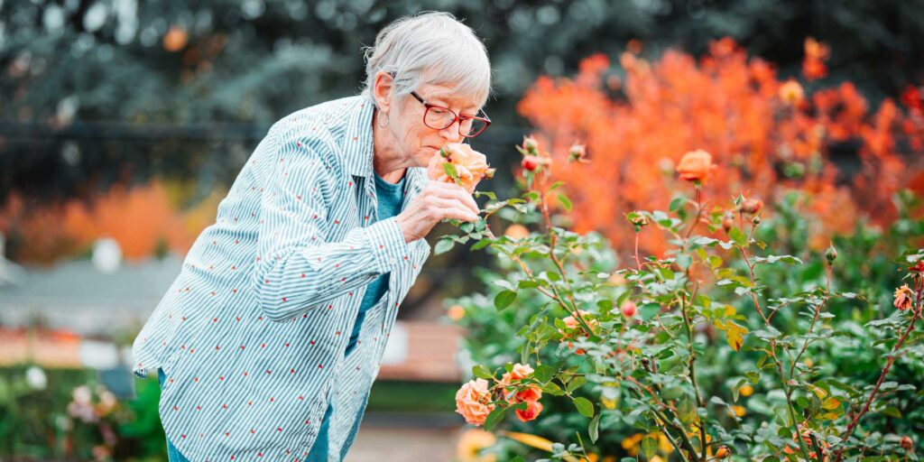 Friendsview resident smelling flowers